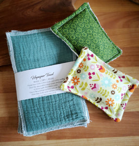 Set of 2 plastic free sponges in green floral designs styled with a pack of green unpaper towels